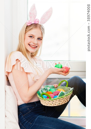 Teenage girl holding Easter eggs 38974008