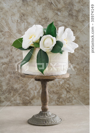 Naked wedding cake with camellias 38974149