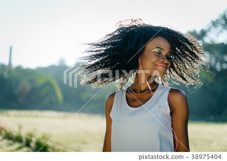 The charming young african girl with green shadows The charming young african girl with green shadows 38975404