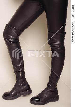 Slim women's legs in black  stylish high boots 38976003