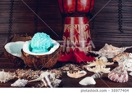 Blue ice cream in coconut bowl. 38977404