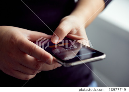 Woman signs up for banking with their mobile phone Woman signs up for banking with their mobile phone 38977749