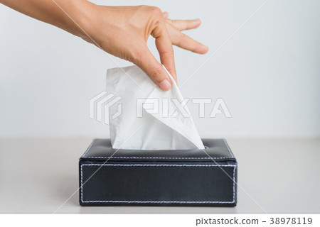 Woman hand picking white tissue paper  38978119