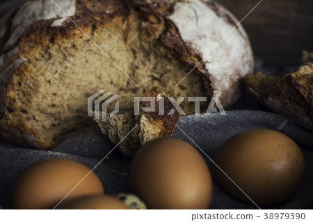 Loaf of rye bread with chicken eggs in wooden box Loaf of rye bread with chicken eggs in wooden box 38979390