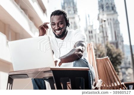 Cheerful entrepreneur having business call Cheerful entrepreneur having business call 38980527