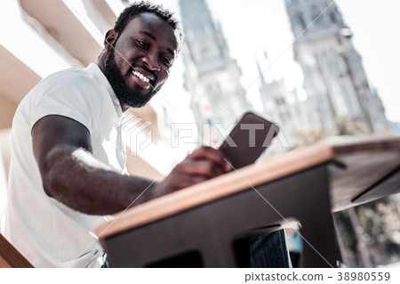 Excited millennial guy reading message on his Excited millennial guy reading message on his 38980559