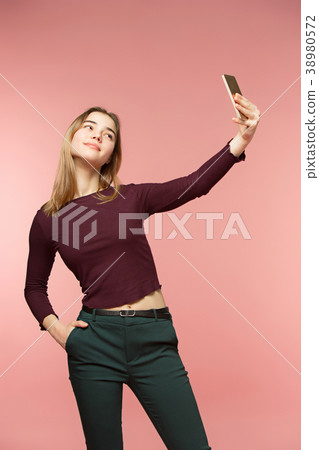 Cute brunette girl takes a selfie. She smiles Cute brunette girl takes a selfie. She smiles 38980572