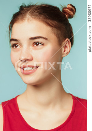 Woman smiling with perfect smile on the blue Woman smiling with perfect smile on the blue 38980675