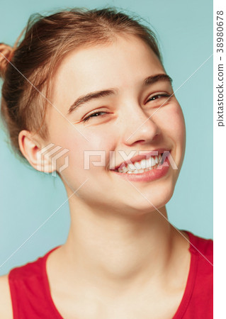 Woman smiling with perfect smile on the blue Woman smiling with perfect smile on the blue 38980678