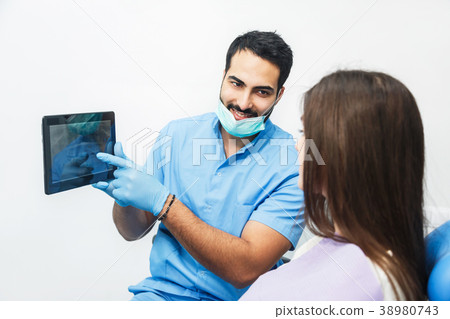 Doctor Shows Teeth X-ray on Tablet 38980743