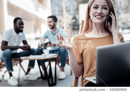 Beautiful young woman enjoying phone conversation Beautiful young woman enjoying phone conversation 38980960