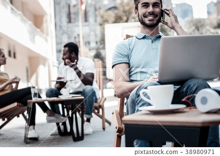 Positive minded millennial guy beaming while Positive minded millennial guy beaming while 38980971