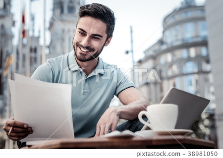 Cheerful businessman working with documents in Cheerful businessman working with documents in 38981050