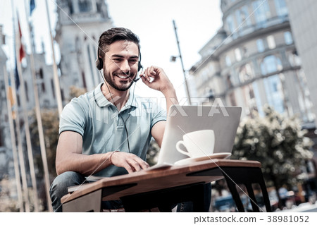 Enthusiastic millennial guy having business video 38981052