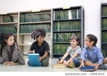 Happy kids reading on the floor. Happy kids reading on the floor. 38981639