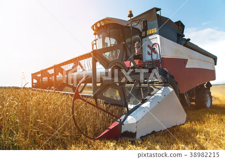 Close up The work of a combine harvester on a Close up The work of a combine harvester on a 38982215
