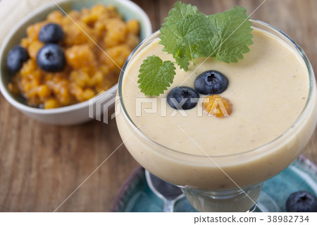 Smoothies with cloudberries  and a blueberry 38982734