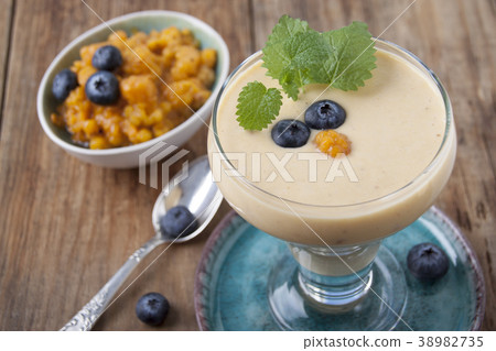 Smoothies with cloudberries and a blueberry 38982735