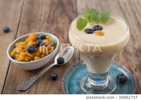 Smoothies with cloudberries  and a blueberry 38982737