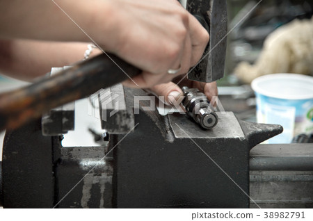 Male hands dismantle a mechanical diesel nozzle to Male hands dismantle a mechanical diesel nozzle to 38982791