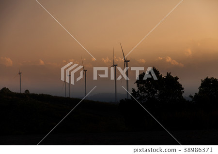 Wind turbine farm of silhouette at sunset. 38986371
