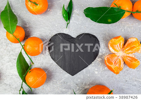 Tangerine around with black slate heart shaped. Tangerine around with black slate heart shaped. 38987426