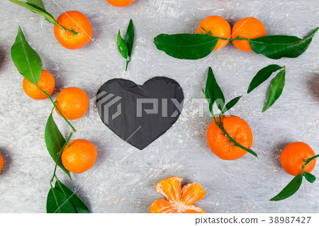Tangerine around with black slate heart shaped. Tangerine around with black slate heart shaped. 38987427
