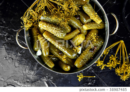 Canned cucumbers in a metal pan. Canned cucumbers in a metal pan. 38987485