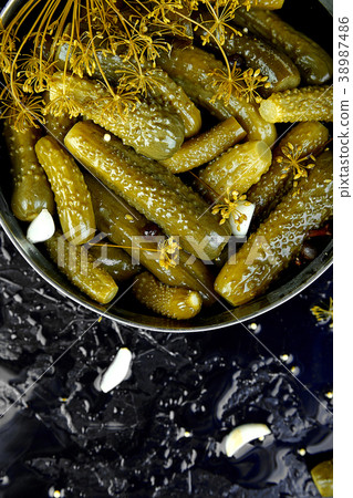 Canned cucumbers in a metal pan. Canned cucumbers in a metal pan. 38987486