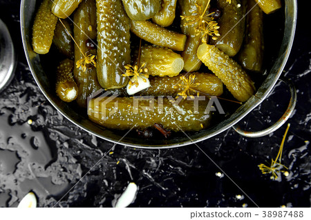 Canned cucumbers in a metal pan. 38987488