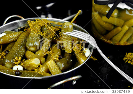 Canned cucumbers in a metal pan. Canned cucumbers in a metal pan. 38987489