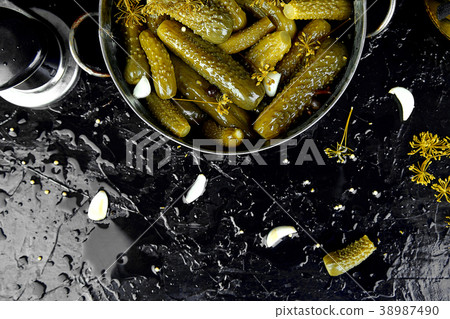 Canned cucumbers in a metal pan. 38987490