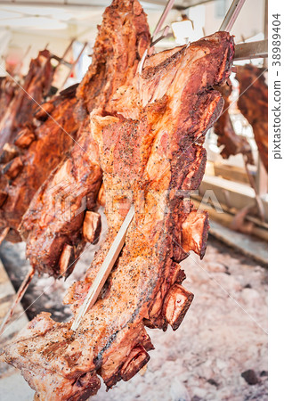 Roasted meat of beef cooking.  38989404