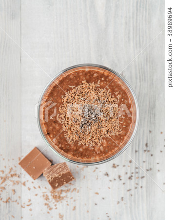Chocolate chia pudding in glass on gray table Chocolate chia pudding in glass on gray table 38989694