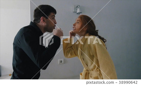 attractive angry couple fighting and shouting at attractive angry couple fighting and shouting at 38990642