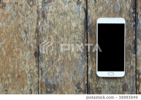 Smartphone on old wood desk on top view. 38993849