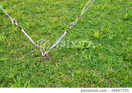 Iron tie rod with green grass Iron tie rod with green grass 38997705