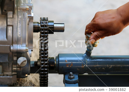 Asian people are repair or maintenance engine 39001882