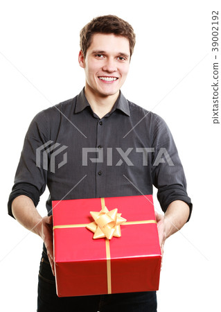 Holiday. Man giving red gift box with golden ribbon Holiday. Man giving red gift box with golden ribbon 39002192