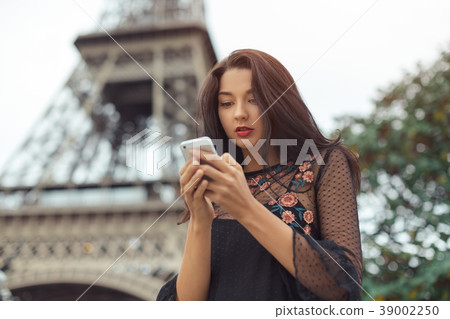 Travel woman using smartphone near the Eiffel Travel woman using smartphone near the Eiffel 39002250