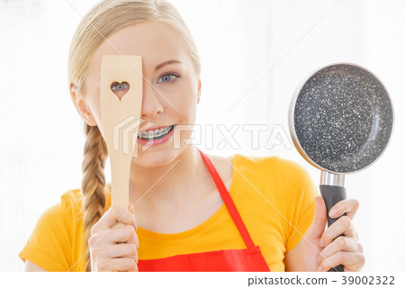 Woman holding cooking pan and spatula 39002322