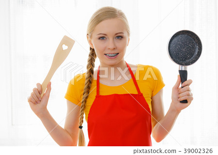 Woman holding cooking pan and spatula 39002326