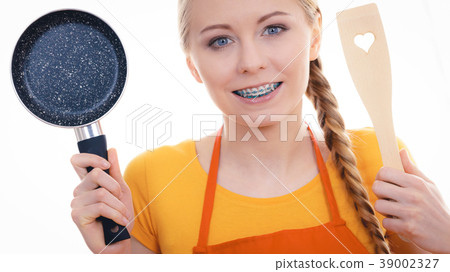 Woman holding cooking pan and spatula 39002327