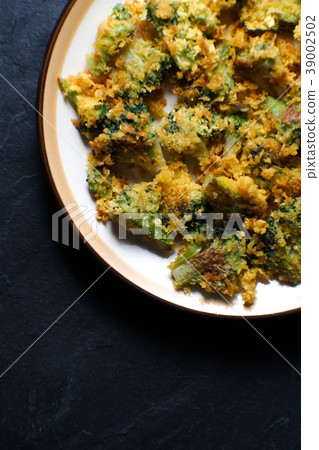 Fried tempura broccoli on a ceramic plate. Asian 39002502