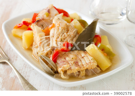 fish stew on white dish on white wooden background fish stew on white dish on white wooden background 39002578