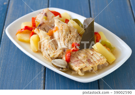 fish stew on white dish on blue wooden background 39002590