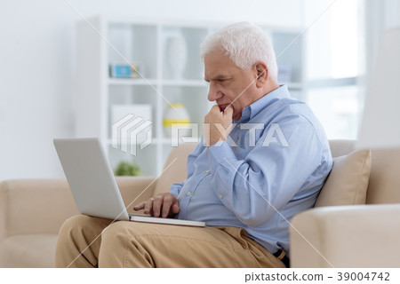 Aged man working on laptop Aged man working on laptop 39004742