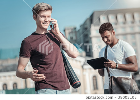 Pleasant blonde man talking on the phone 39005105