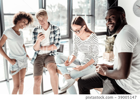 Pleasant young woman taking notes 39005147