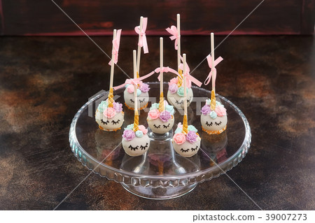 Sweet cake pops with faces on wooden background 39007273